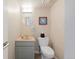 Cozy half bath with a stylish sink, toilet, and modern fixtures at 42 Blue Sage, Littleton, CO 80127