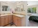 Bathroom featuring double sink vanity, ample counter space, and modern fixtures at 42 Blue Sage, Littleton, CO 80127
