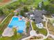 Aerial view of a luxurious community pool with a water slide, lounge areas, and verdant landscaping at 42 Blue Sage, Littleton, CO 80127