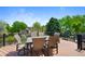 Outdoor dining on a spacious deck with black metal railing and views of the landscaped backyard at 42 Blue Sage, Littleton, CO 80127