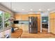 Cozy dining area with wood floors, a view of the back deck, and a stainless steel refrigerator at 42 Blue Sage, Littleton, CO 80127