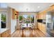 Bright dining area with wood floors, a window overlooking the backyard, and wood cabinets at 42 Blue Sage, Littleton, CO 80127