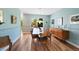 Formal dining room with wainscoting, modern lighting, wood floors, and ample space for entertaining at 42 Blue Sage, Littleton, CO 80127