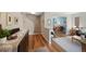 Inviting entryway with hardwood floors, console table, and seamless flow to the living area at 42 Blue Sage, Littleton, CO 80127