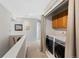 Convenient upstairs laundry area with modern appliances, cabinets, and closet space near the bedrooms at 42 Blue Sage, Littleton, CO 80127