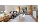 Bright living room with stylish sofa, light wood floors, and a large window view at 42 Blue Sage, Littleton, CO 80127