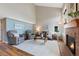 Spacious living room with vaulted ceilings, a brick fireplace, wood floors, and neutral wall colors at 42 Blue Sage, Littleton, CO 80127