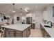 Modern kitchen has large island, stainless-steel appliances, modern cabinetry, and is open to the dining area at 375 Marshall Rd, Superior, CO 80027