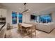 Bright living room with a dining area, a fireplace, and expansive windows, showcasing an open concept design at 375 Marshall Rd, Superior, CO 80027