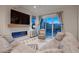 Cozy living room featuring a fireplace, plush sofa, and a sliding glass door to balcony with mountain views at 375 Marshall Rd, Superior, CO 80027