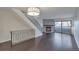 Inviting living room with fireplace, dark wood floors, and stairs with decorative metal railing at 8765 W Cornell Ave # 3, Lakewood, CO 80227