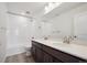 Bright bathroom featuring a double vanity, white countertops, and a shower-tub combination at 1376 Lumber Ridge N Cir, Erie, CO 80516