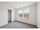 Well-lit bedroom with neutral carpeting, a closet, and bright double window at 1376 Lumber Ridge N Cir, Erie, CO 80516