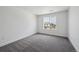 Bright bedroom with neutral carpeting, a large window overlooking other homes at 1376 Lumber Ridge N Cir, Erie, CO 80516