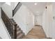 Inviting entryway with hardwood floors, staircase with dark wood railings and white trim at 1376 Lumber Ridge N Cir, Erie, CO 80516