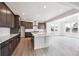 Modern kitchen with stainless steel appliances, a central island, and ample cabinet space at 1376 Lumber Ridge N Cir, Erie, CO 80516
