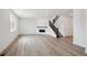 Spacious living room with hardwood floors, a modern fireplace, and staircase at 1376 Lumber Ridge N Cir, Erie, CO 80516