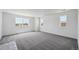 Spacious living room with neutral carpeting and lots of windows for natural light at 1376 Lumber Ridge N Cir, Erie, CO 80516