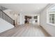 Open concept living space with hardwood floors, kitchen, and staircase at 1376 Lumber Ridge N Cir, Erie, CO 80516
