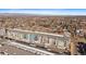 Aerial view of condo development with tree lined streets, city scape and rocky mountains in the distance at 420 E Fremont Pl # 203, Centennial, CO 80122