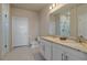 Bright bathroom with dual sinks, granite countertop, and a sleek, glass-enclosed shower stall at 420 E Fremont Pl # 203, Centennial, CO 80122