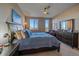 Comfortable bedroom featuring large windows, a bed, and a dresser at 420 E Fremont Pl # 203, Centennial, CO 80122