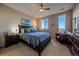 Cozy bedroom featuring a large bed, wooden furniture, and natural light from two windows at 420 E Fremont Pl # 203, Centennial, CO 80122