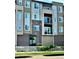 Modern condo building with brick and siding, featuring balconies and well-maintained landscaping at 420 E Fremont Pl # 203, Centennial, CO 80122