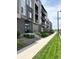 Modern condo building exterior highlighting balconies, landscaping and nearby sidewalk at 420 E Fremont Pl # 203, Centennial, CO 80122