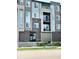 Modern condo building featuring brick accents and private balconies with stylish railings at 420 E Fremont Pl # 203, Centennial, CO 80122