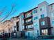 Modern apartment building exterior with balconies under a clear blue sky at 420 E Fremont Pl # 203, Centennial, CO 80122