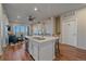 Open-concept kitchen with an island, stainless steel appliances, and easy access to living area and balcony at 420 E Fremont Pl # 203, Centennial, CO 80122