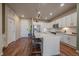 A well-lit kitchen showcasing an island, stainless steel appliances, and white cabinetry at 420 E Fremont Pl # 203, Centennial, CO 80122