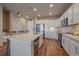 Modern kitchen featuring white cabinets, stainless appliances, a large island, and hardwood floors at 420 E Fremont Pl # 203, Centennial, CO 80122