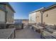 Spacious rooftop deck with built-in barbeque, outdoor dining furniture and inviting fire pit lounge at 420 E Fremont Pl # 203, Centennial, CO 80122