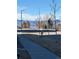 Street view with mountains in the background, trees, and sidewalk at 420 E Fremont Pl # 203, Centennial, CO 80122