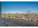 Scenic view from a window of a neighborhood with mature trees and distant mountains on a clear day at 420 E Fremont Pl # 203, Centennial, CO 80122