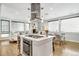 Modern kitchen island with cooktop and stainless steel range hood at 3026 Zuni St, Denver, CO 80211