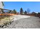 Large backyard with a deck and snow on the ground at 600 Balsa Dr, Castle Rock, CO 80104