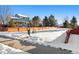 Backyard view of a home with a wooden fence and snow at 600 Balsa Dr, Castle Rock, CO 80104