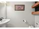 Clean bathroom with pedestal sink and wood shelves at 600 Balsa Dr, Castle Rock, CO 80104