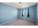 Light blue bedroom with window and neutral carpet at 600 Balsa Dr, Castle Rock, CO 80104