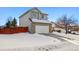 Two-story house with a white garage door and snow-covered driveway at 600 Balsa Dr, Castle Rock, CO 80104