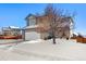 Two-story house with a white garage door and snow-covered yard at 600 Balsa Dr, Castle Rock, CO 80104