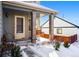 Covered porch with a wooden swing and brick columns at 600 Balsa Dr, Castle Rock, CO 80104