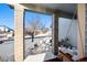 View from a covered porch with a wooden swing and snowy yard at 600 Balsa Dr, Castle Rock, CO 80104