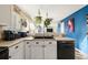 White kitchen cabinets, double sink, and a view to the living room at 600 Balsa Dr, Castle Rock, CO 80104