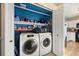 Laundry room with washer, dryer, and storage shelves at 600 Balsa Dr, Castle Rock, CO 80104