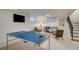 Recreational room features a ping pong table, a sofa, and access to the stairwell at 3434 S Race St, Englewood, CO 80113