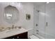 Bright bathroom with a shower-tub combo and vanity with a framed mirror at 3434 S Race St, Englewood, CO 80113